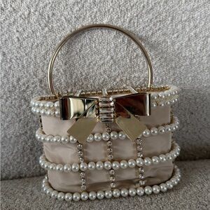 Rosantica Pearl-Embellished Cream Handbag with Gold Bow Handle